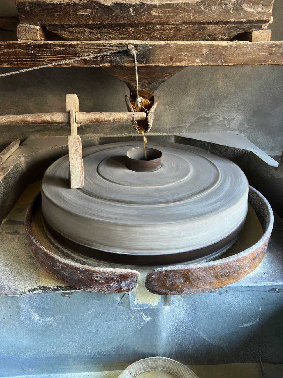 Old-fashioned stone mill used for grinding grains. Highlights traditional milling techniques.
