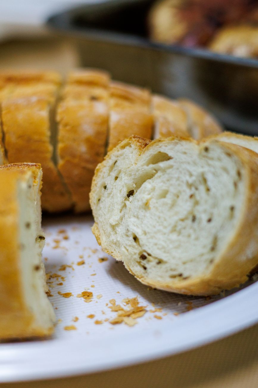 Fresh sliced artisan bread displayed on a plate, highlighting texture.